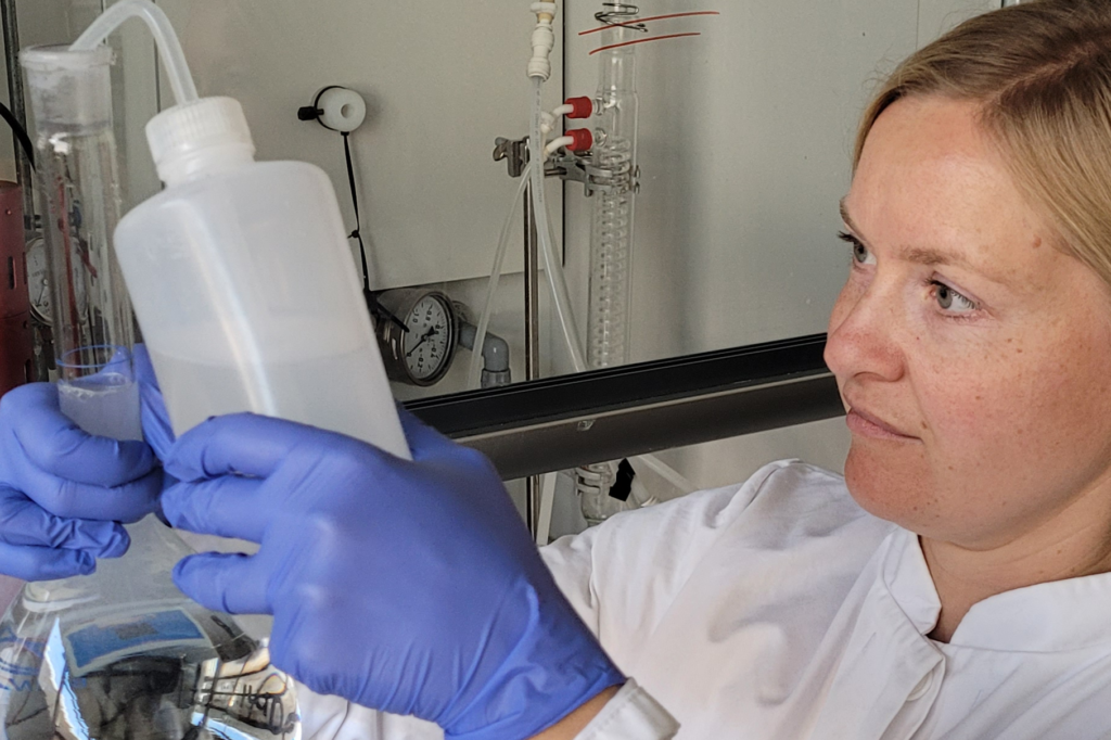 Female chemist holds test material